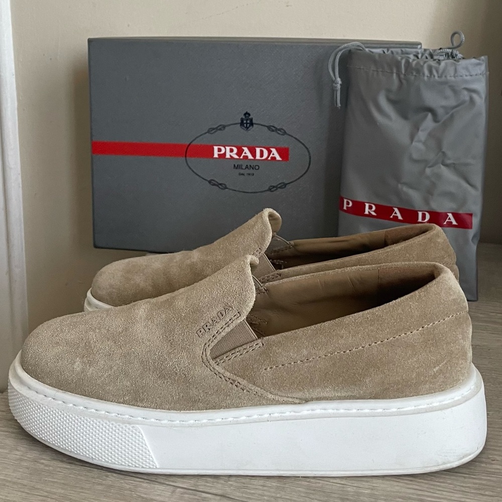 Pre-owned. Authentic Prada Slip-ons. Comes with box and dust bag.